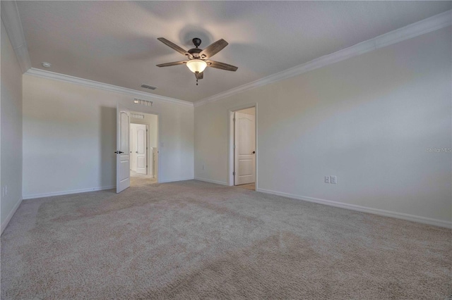 spare room featuring ceiling fan, light colored carpet, and crown molding