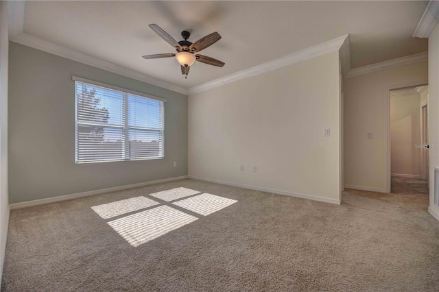 carpeted empty room with ceiling fan and ornamental molding