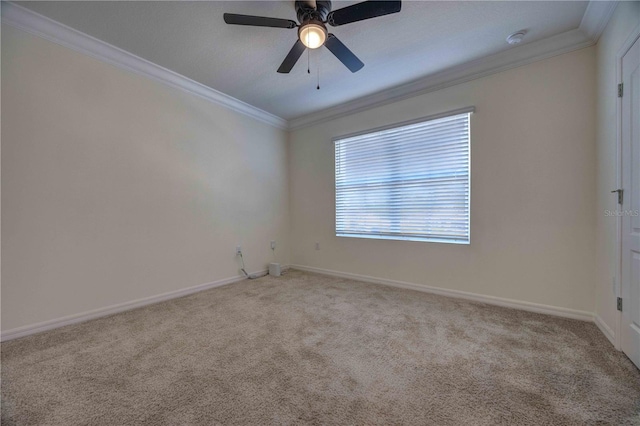 carpeted empty room featuring ceiling fan and crown molding