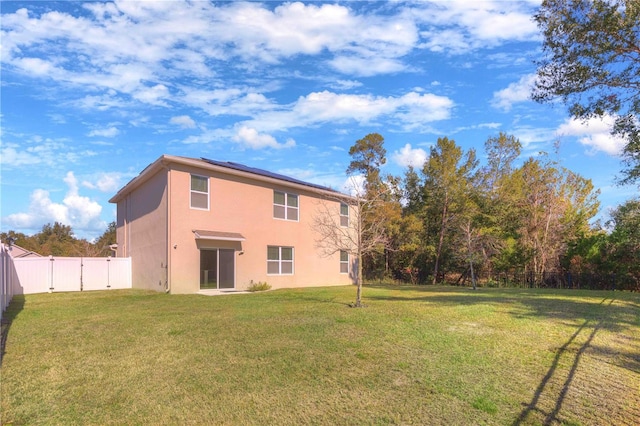 back of property featuring a lawn