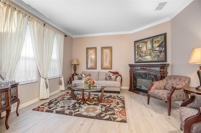 living room featuring light wood-type flooring and crown molding