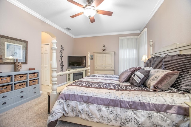 bedroom featuring ceiling fan, ornamental molding, and carpet flooring