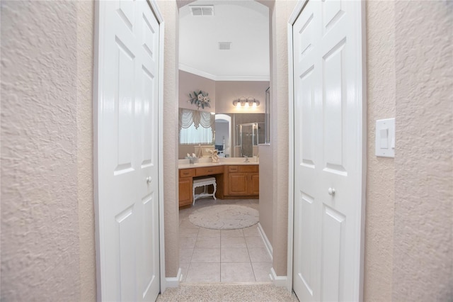 bathroom featuring vanity, tile patterned floors, and crown molding