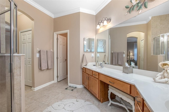 bathroom featuring vanity, tile patterned flooring, a shower with door, and ornamental molding