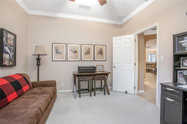 interior space featuring ceiling fan, light carpet, and crown molding