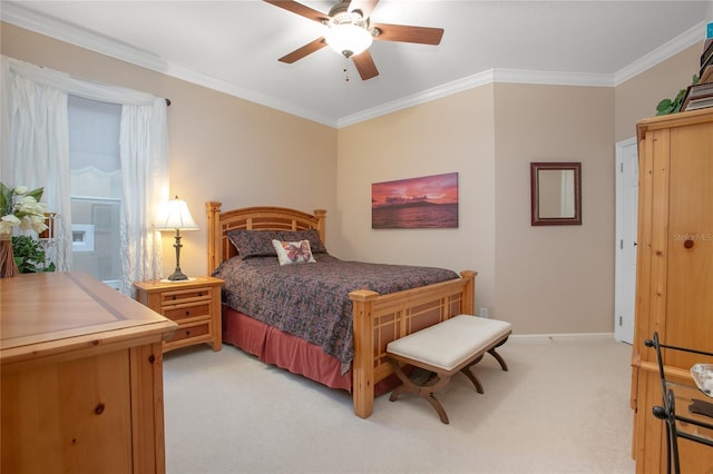 carpeted bedroom with ceiling fan and ornamental molding