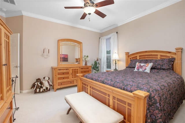 carpeted bedroom featuring ceiling fan and crown molding