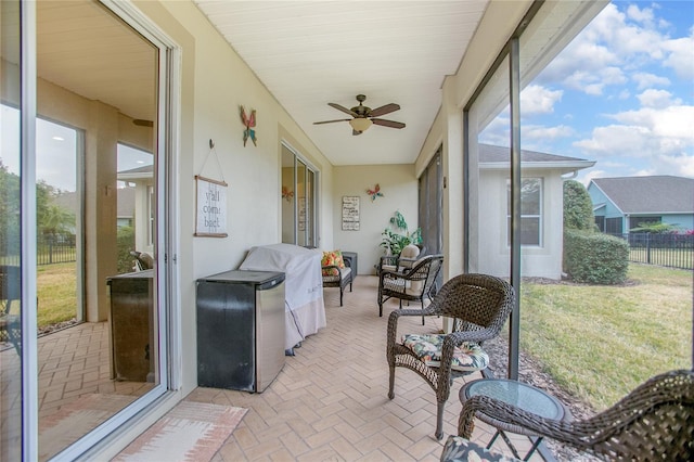 sunroom featuring ceiling fan