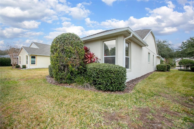 view of side of property with a yard