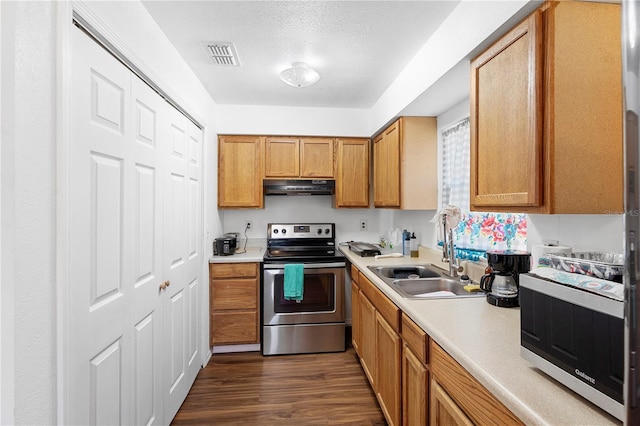 kitchen with dark hardwood / wood-style floors, stainless steel appliances, sink, and extractor fan