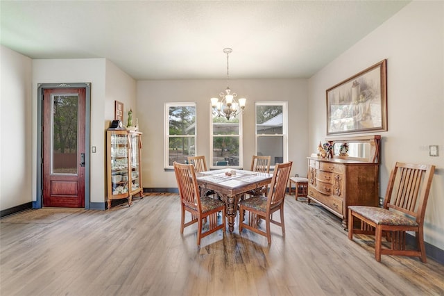 dining area featuring a chandelier and light hardwood / wood-style flooring