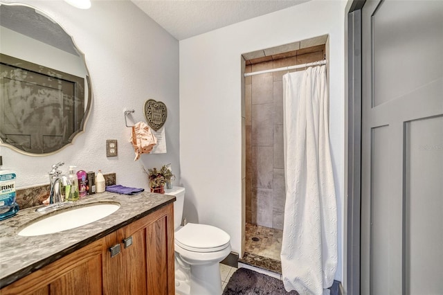 bathroom with toilet, vanity, a textured ceiling, and curtained shower