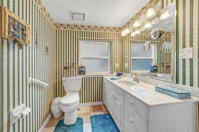 bathroom featuring toilet, vanity, and tile patterned floors