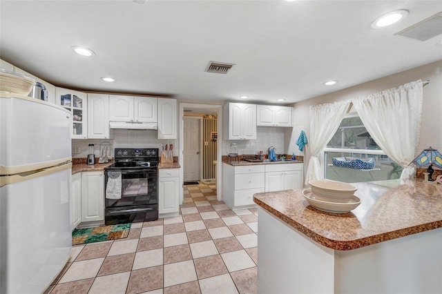 kitchen with white cabinetry, sink, backsplash, black electric range oven, and fridge