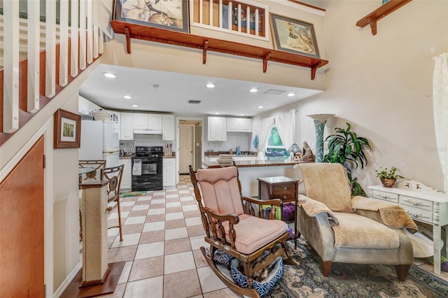 tiled living room featuring a towering ceiling