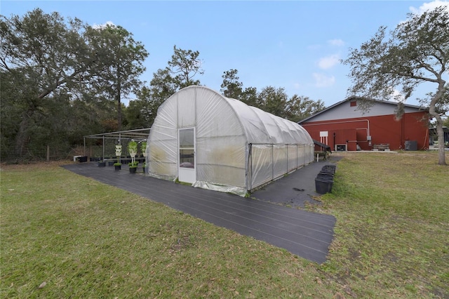 view of outdoor structure featuring a lawn