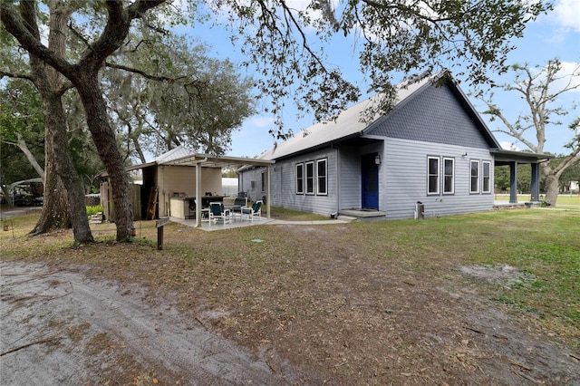 back of house with a lawn, a pergola, and a patio