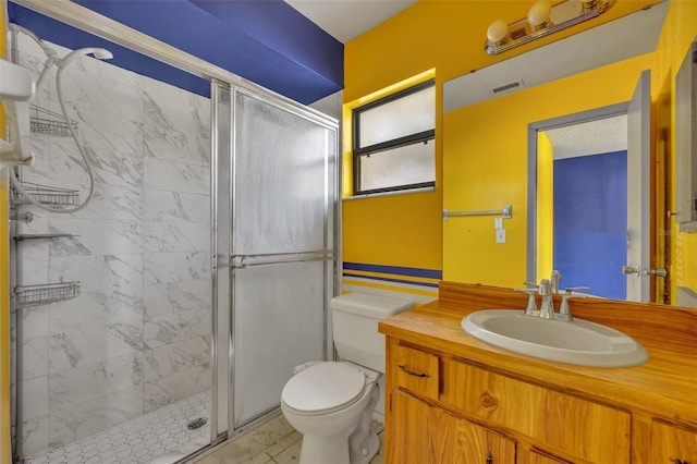 bathroom with an enclosed shower, vanity, and toilet