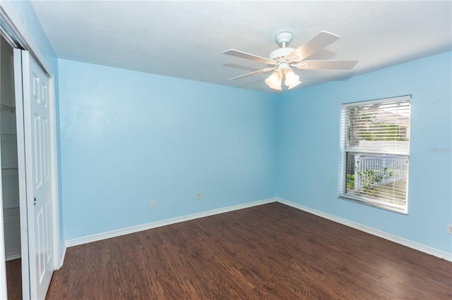 unfurnished room featuring dark hardwood / wood-style floors and ceiling fan