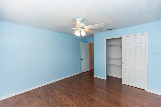 unfurnished bedroom featuring dark hardwood / wood-style flooring, a closet, and ceiling fan