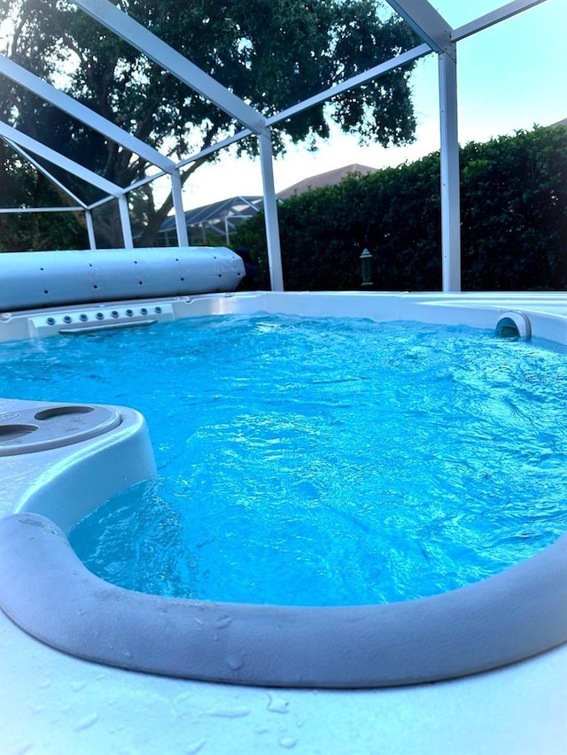 view of swimming pool with glass enclosure