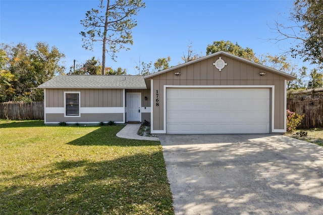 ranch-style home featuring a garage and a front lawn