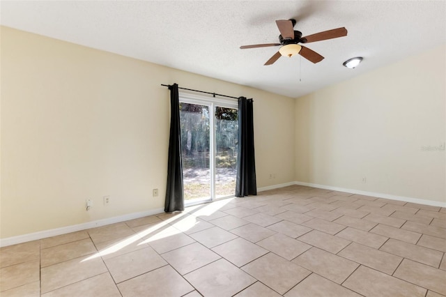 empty room with light tile patterned floors, a textured ceiling, and ceiling fan