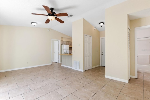 unfurnished living room featuring light tile patterned flooring, ceiling fan, and vaulted ceiling