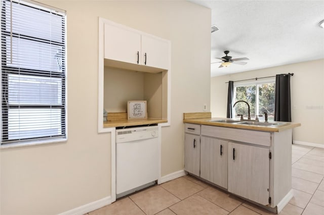 kitchen featuring sink, kitchen peninsula, dishwasher, and light tile patterned flooring