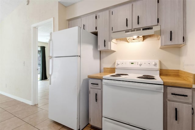 kitchen with light tile patterned floors and white appliances