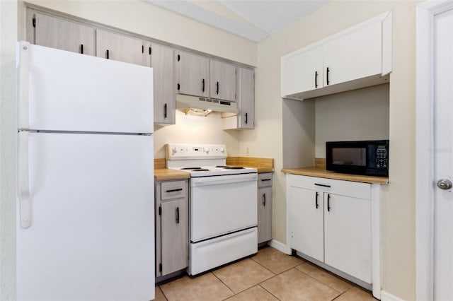 kitchen featuring light tile patterned floors and white appliances