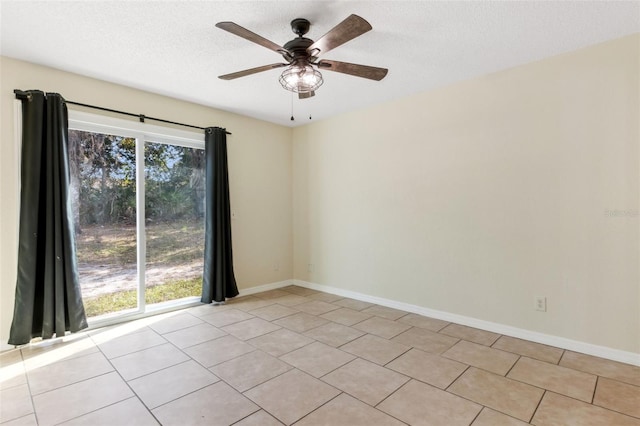 spare room featuring light tile patterned flooring, ceiling fan, and a textured ceiling