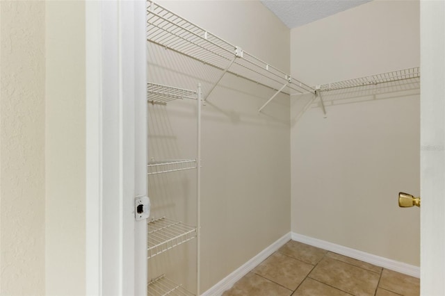 spacious closet with tile patterned floors