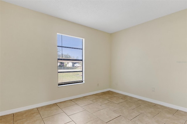 unfurnished room featuring light tile patterned floors