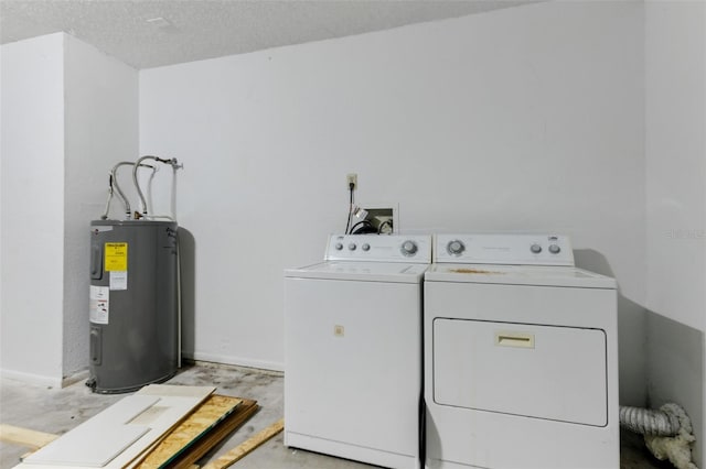 laundry area with electric water heater, washing machine and clothes dryer, and a textured ceiling