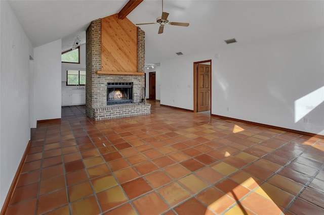 unfurnished living room with visible vents, high vaulted ceiling, beam ceiling, a fireplace, and tile patterned flooring