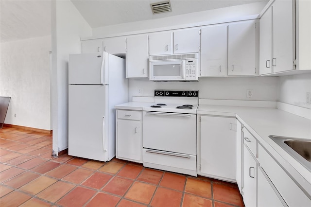 kitchen with visible vents, white appliances, white cabinets, and light countertops