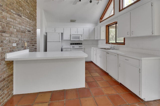 kitchen with visible vents, a sink, white appliances, a peninsula, and light countertops