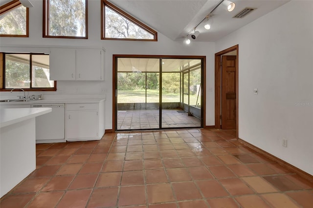 doorway featuring light tile patterned floors, visible vents, track lighting, and a sink