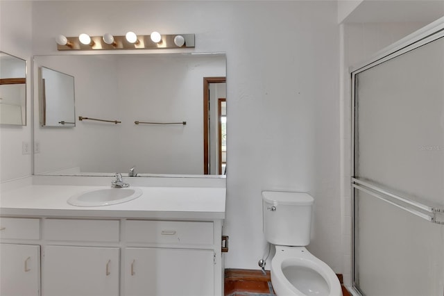 full bathroom with a shower with door, toilet, and vanity