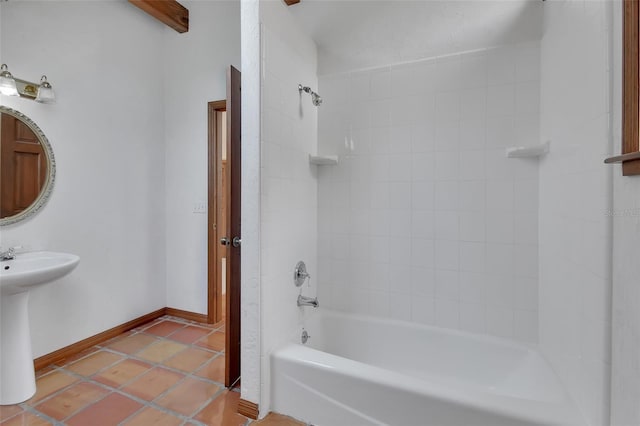 full bath with a sink, baseboards, shower / bathtub combination, and tile patterned flooring