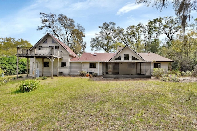 rear view of property featuring a yard, central air condition unit, a deck, and a chimney