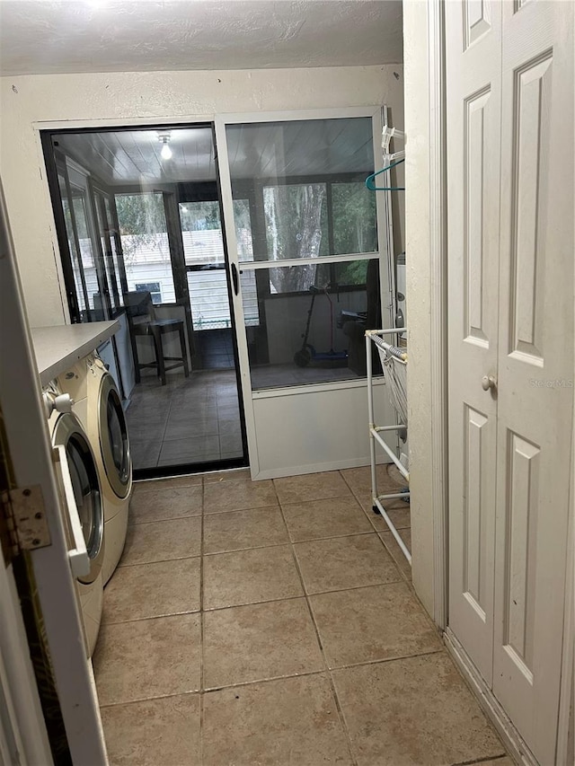 laundry area with light tile patterned floors