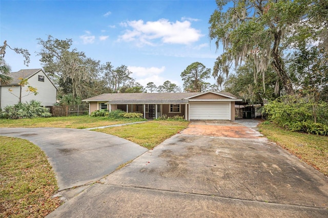 ranch-style home featuring a garage and a front yard