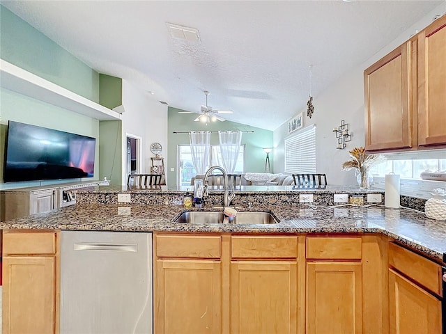 kitchen with lofted ceiling, sink, a textured ceiling, dishwasher, and ceiling fan