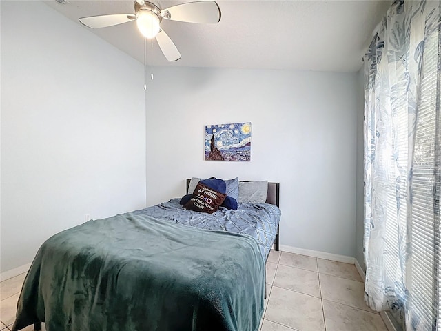 bedroom with ceiling fan and light tile patterned floors