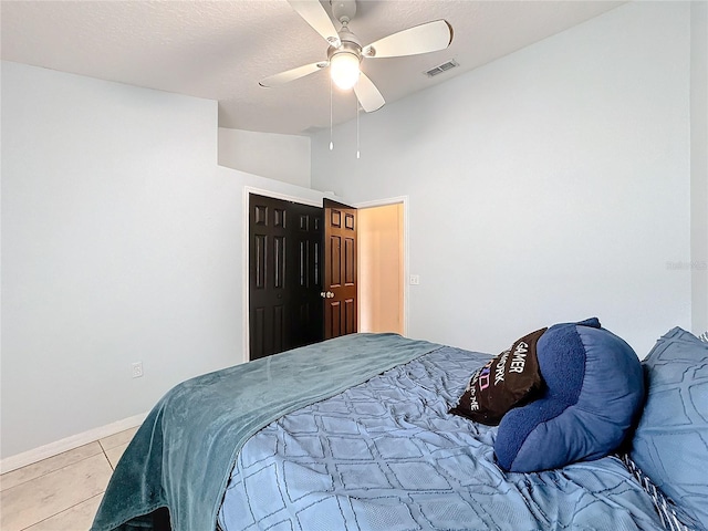 tiled bedroom featuring vaulted ceiling and ceiling fan