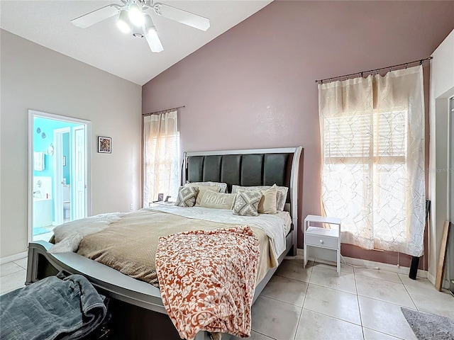 tiled bedroom with ceiling fan, lofted ceiling, ensuite bath, and multiple windows