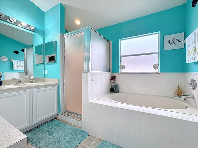 bathroom with vanity, tile patterned floors, and shower with separate bathtub