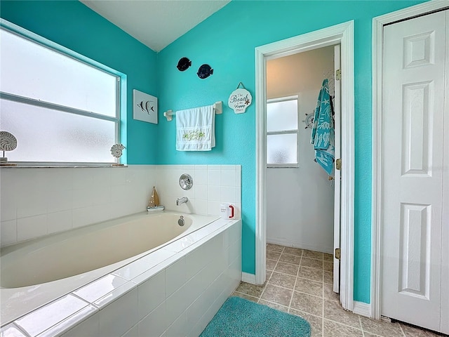 bathroom featuring tiled tub